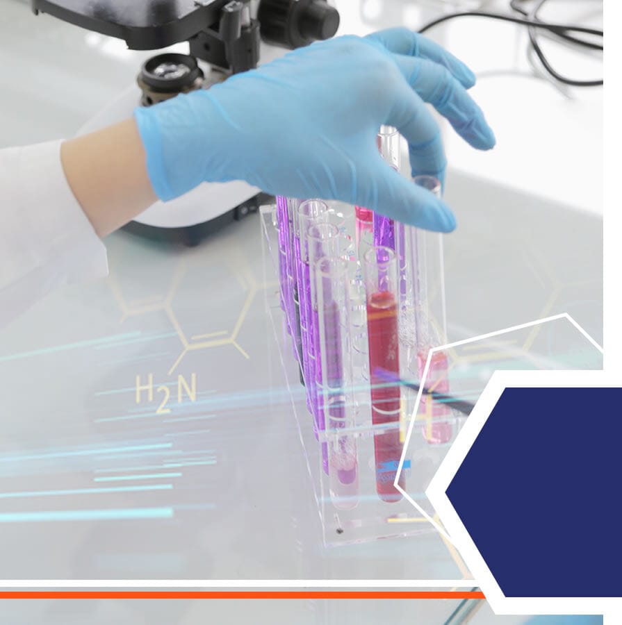 A gloved hand placing sample tubes in a rack